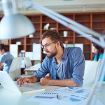 Young man working on laptop in the workplace with good air quality