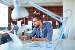 Young man working on laptop in the workplace with good air quality