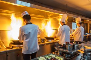 Restaurant kitchen releasing smoke and grease into the air systems