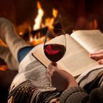 woman reading by the fireplace