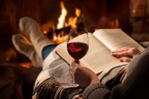 woman reading by the fireplace