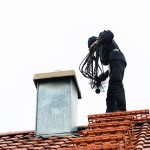 man cleaning chimney