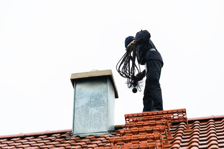 man cleaning chimney